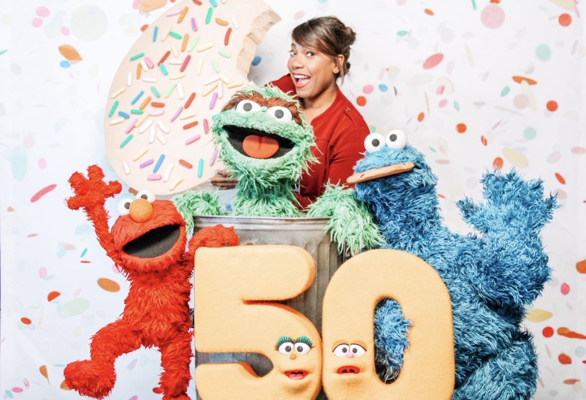 Jas with Elmo, Oscar the Grouch, and Cookie Monster at Sesame Street's 50th anniversary
